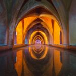 Beautiful Gothic arches reflecting in water, vibrant colors create a mesmerizing effect.
